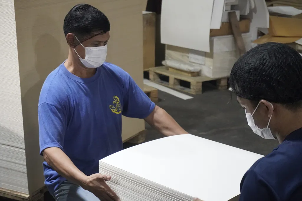 Fil-Anchor staff inspecting sheeted paper stock